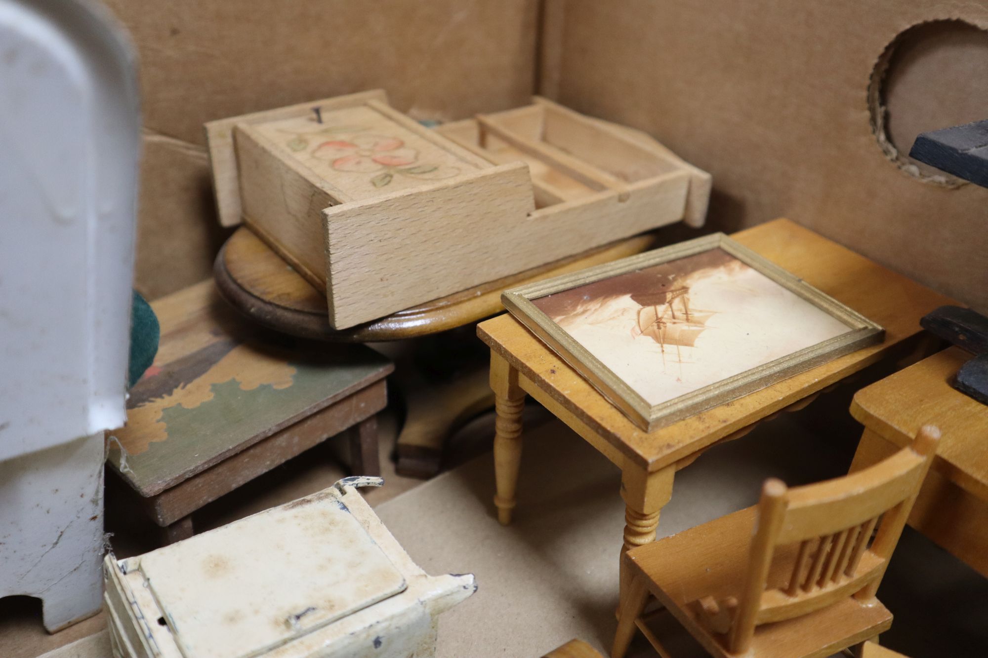 A collection of dolls and dolls house furniture displayed in room settings in a pine cupboard, width 84cm, depth 36cm, height 132cm